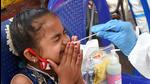 A healthcare worker collects a swab sample of a baby for the Covid-19 test at City Railway Station, in Bengaluru on Friday. (ANI)