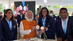 The image shows PM Modi with PV Sindhu.