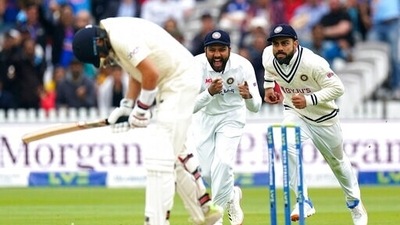 India's Virat Kohli, right, celebrates catching the ball to dismiss England's Joe Root during day five of the Second Test match at Lord's, London, Monday Aug. 16, 2021. (AP)