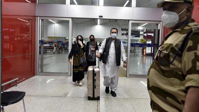 Passengers from Kabul, Afghanistan, arrive at T3 Indira Gandhi International Airport in New Delhi on Sunday, August 15. (Sanjeev Verma/HT photo) Passengers from Kabul, Afghanistan, arrive at T3 Indira Gandhi International Airport in New Delhi on Sunday, August 15. (Sanjeev Verma/HT photo)