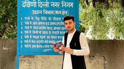 Obaidullah Mobarez, a DU student, who arrived last month from Laghman, Afghanistan, holding the Lonely Planet Afghanistan near his home in south Delhi’s Bhogal. (Mayank Austen Soofi)