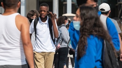 A student holds his cell phone to his ear as he leaves E.D. Walker Middle School after the first day of school in Dallas, on Monday, Aug. 16, 2021. (Ben Torres/The Dallas Morning News via AP) (AP)