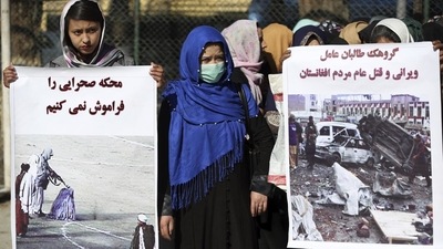 Afghan civil society activists hold banners in Dari that read: "We cannot forget the court-martials, and Taliban group are the factor of destruction and genocide". (AP / File) Afghan civil society activists hold banners in Dari that read: "We cannot forget the court-martials, and Taliban group are the factor of destruction and genocide". (AP / File)