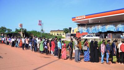 Travellers wait in a queue to get their Covid-19 test report checked by officials at Talapady checkpost at Kerala-Karnataka border in Mangaluru, on August 2. (PTI) Travellers wait in a queue to get their Covid-19 test report checked by officials at Talapady checkpost at Kerala-Karnataka border in Mangaluru, on August 2. (PTI)