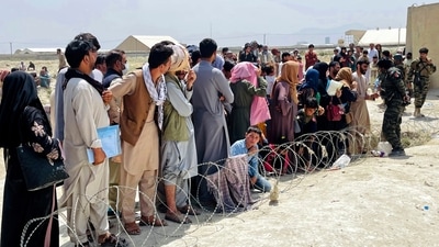 Afghan security guards try to maintain order as hundreds gather outside the international airport in Kabul, Afghanistan. (AP) Afghan security guards try to maintain order as hundreds gather outside the international airport in Kabul, Afghanistan. (AP)