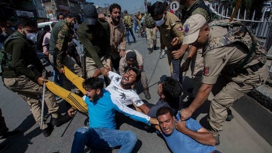 Kashmiri Muslims react as they are detained by police as devotees defy restrictions for a Muharram procession in Srinagar. (AFP)