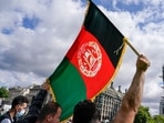 A demonstrator walks holding an Afghanistan flag, during a protest at Parliament Square in London: Representational image(AP) A demonstrator walks holding an Afghanistan flag, during a protest at Parliament Square in London: Representational image(AP)