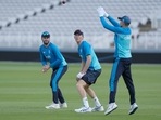 England's Dom Sibley (L) and England's Zak Crawley watch as captain Joe Root leaps to take a catch during a practice session(AP)