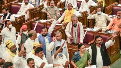 Opposition members protest during the Monsoon session of the Uttar Pradesh assembly in Lucknow on Wednesday, demanding a discussion on inflation. (PTI Photo)