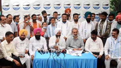 The newly inducted members with AAP leaders Pradeep Chhabra and Jarnail Singh in Chandigarh on Wednesday. (Ravi Kumar/HT)