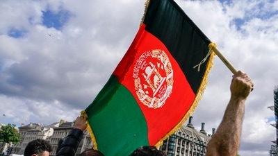 A demonstrator walks holding an Afghanistan flag, during a protest at Parliament Square in London: Representational image (AP) A demonstrator walks holding an Afghanistan flag, during a protest at Parliament Square in London: Representational image (AP)
