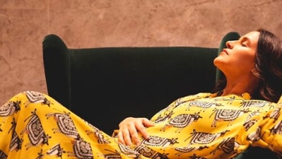 Neha Dhupia keeps it comfy yet stylish in this long, printed yellow Masaba Gupta dress. (Instagram/@nehadhupia)