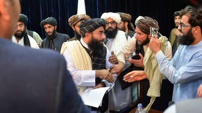 Taliban spokesperson Zabihullah Mujahid interacts after addressing the press conference. (AFP) Taliban spokesperson Zabihullah Mujahid interacts after addressing the press conference. (AFP)
