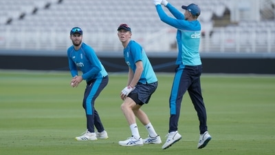 England's Dom Sibley (L) and England's Zak Crawley watch as captain  Joe Root leaps to take a catch during a practice session (AP)