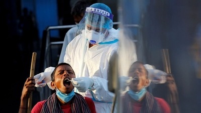 A healthcare worker collects a coronavirus disease (Covid-19) test swab sample from a man.&nbsp; (File Photo / REUTERS)