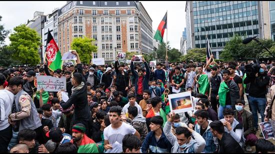 Afghans take part in a protest over Taliban takeover of Afghanistan in Brussels, Belgium on Wednesday. (AFP)