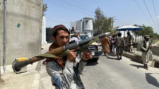 A Taliban fighter holds a rocket propelled grenade as he stands guard at an entrance gate outside the interior ministry in Kabul on Tuesday. (AFP Photo)
