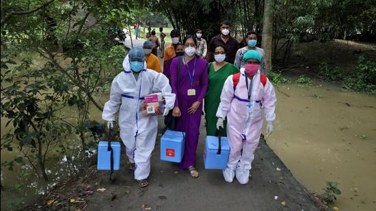 Healthcare workers carry vaccines during a door-to-door vaccination and testing drive in West Bengal. (REUTERS File)