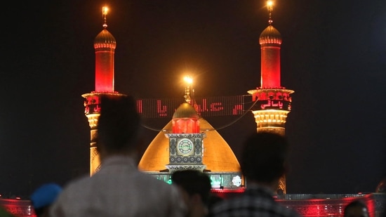 Iraqi Shiite Muslims take part in a mourning procession during the month of Muharram leading up to the day of Ashura, at the Imam Abbas shrine in Iraq's holy city of Karbala(Photo by Mohammed SAWAF/AFP)