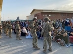 G7 called for the militants to guarantee safe passage to Afghan nationals and foreigners who want to leave the country. In picture - US soldiers stand guard as Afghan people wait to board a military aircraft to leave Afghanistan at the airport in Kabul.(AFP) G7 called for the militants to guarantee safe passage to Afghan nationals and foreigners who want to leave the country. In picture - US soldiers stand guard as Afghan people wait to board a military aircraft to leave Afghanistan at the airport in Kabul.(AFP)