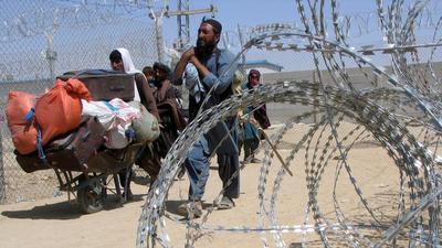 A family arriving from Afghanistan make their way through the friendship gate crossing point at the Pakistan-Afghanistan border town of Chaman, Pakistan (REUTERS) A family arriving from Afghanistan make their way through the friendship gate crossing point at the Pakistan-Afghanistan border town of Chaman, Pakistan (REUTERS)