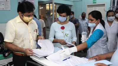 Chief medical officer Dr Virender Yadav (left) was at the Sector 10 Civil Hospital at 8.30am. (Vipin Kumar/HT PHOTO) Chief medical officer Dr Virender Yadav (left) was at the Sector 10 Civil Hospital at 8.30am. (Vipin Kumar/HT PHOTO)