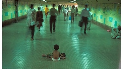 An image of two street children sitting still in a subway tunnel as the fast-paced city moves around them captured by Raghu Rai in Mumbai, 1995. (Instagram / Raghu Rai ) An image of two street children sitting still in a subway tunnel as the fast-paced city moves around them captured by Raghu Rai in Mumbai, 1995. (Instagram / Raghu Rai )