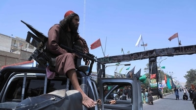 A Taliban fighter stands guard atop a vehicle near the site of an Ashura procession which is held to mark the death of Imam Hussein. (AFP)