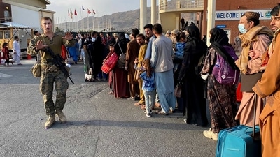 Afghan people queue up to board a US military aircraft to leave Afghanistan at the military airport in Kabul. (AFP) Afghan people queue up to board a US military aircraft to leave Afghanistan at the military airport in Kabul. (AFP)