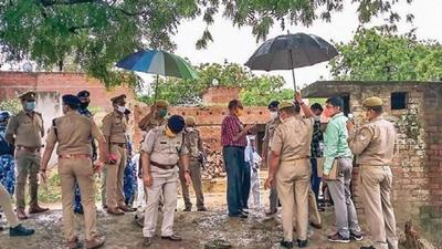 Police officials at the Bikru village after the ambush in July last year. Vikas Dubey and his gang members had allegedly killed eight police personnel during a raid on his house. (PTI FILE PHOTO) Police officials at the Bikru village after the ambush in July last year. Vikas Dubey and his gang members had allegedly killed eight police personnel during a raid on his house. (PTI FILE PHOTO)