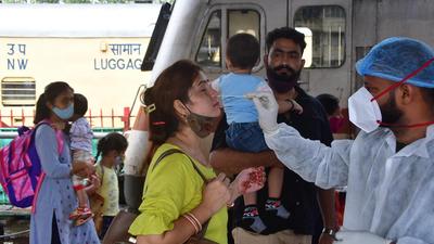 A BMC health worker collects swab samples for Covid-19 test of passengers arriving from outstation trains, at Dadar. (HT PHOTO) A BMC health worker collects swab samples for Covid-19 test of passengers arriving from outstation trains, at Dadar. (HT PHOTO)