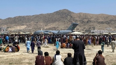 Hundreds of people gather near a US Air Force C-17 transport plane at a perimeter at the international airport in Kabul, Afghanistan, Monday, Aug. 16, 2021 (AP). Hundreds of people gather near a US Air Force C-17 transport plane at a perimeter at the international airport in Kabul, Afghanistan, Monday, Aug. 16, 2021 (AP).