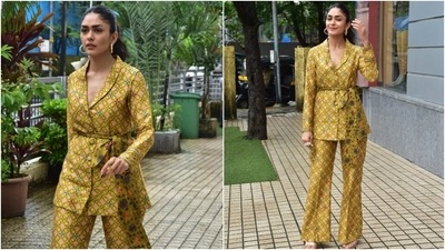 Mrunal's ensemble for the outing was a satin-silk shawl lapel blazer featuring quirky print and front button-up details. The mustard coat had long sleeves and an exaggerated bow to cinch it in on the waist.  (HT Photo/Varinder Chawla)