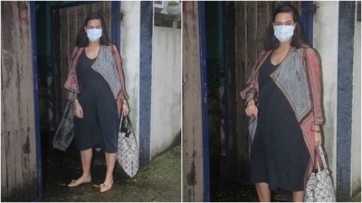 Neha slipped into a deep blue calf-length cotton dress for the outing. The plain ensemble had a scooped neckline and free-flowing silhouette, making it an idle choice for days one wants to channel an effortless and relaxed vibe. (HT Photo/Varinder Chawla)