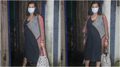 Neha teamed the attire with a face mask, tote bag, and beige bow-adorned ballerinas. The actor and TV show host completed her look with a bracelet, face mask and open tresses.  (HT Photo/Varinder Chawla)