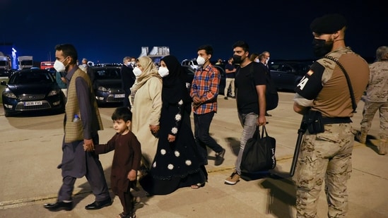 Spanish and Afghan citizens who were evacuated from Kabul arrive at Torrejon airbase in Torrejon de Ardoz, outside Madrid, (REUTERS)