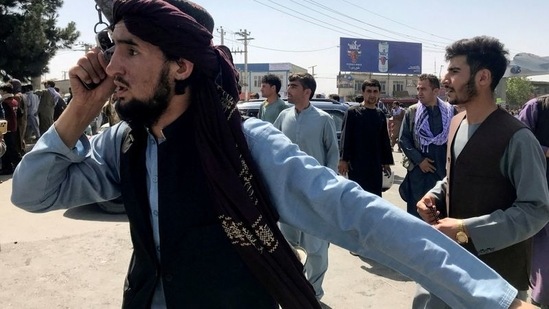 A member of Taliban forces inspects the area outside Hamid Karzai International Airport in Kabul, Afghanistan (REUTERS)