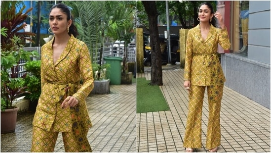 Mrunal's ensemble for the outing was a satin-silk shawl lapel blazer featuring quirky print and front button-up details. The mustard coat had long sleeves and an exaggerated bow to cinch it in on the waist. (HT Photo/Varinder Chawla)