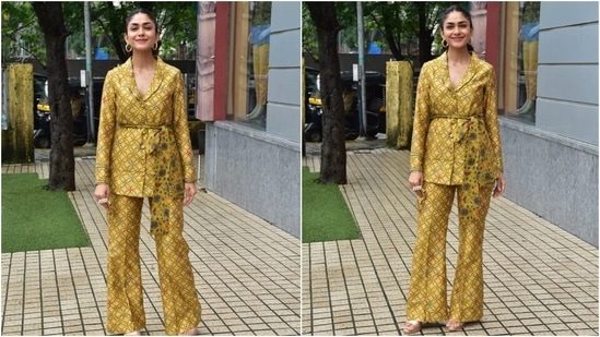 Mrunal accessorised her outfit with textured gold hoop earrings, rings, strappy beige pumps, and a matching face mask with pearl-adorned straps. (HT Photo/Varinder Chawla)