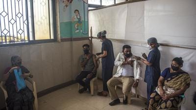 Beneficiaries get inoculated against Covid-19 at a BMC school vaccination centre in Worli Seaface, Mumbai. (HT file photo)