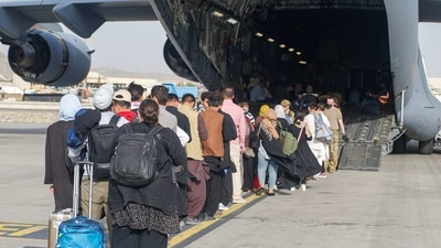 Close to 800 NATO civilian personnel had worked to keep the Kabul international airport running, a statement said. In picture - Evacuees board a C-17 Globemaster III during an evacuation at Hamid Karzai International Airport, Afghanistan. (Reuters)