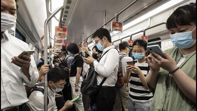 Passengers use their smartphones while riding a subway train in Shanghai, China. (Bloomberg) Passengers use their smartphones while riding a subway train in Shanghai, China. (Bloomberg)