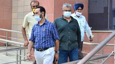 Davinder Sandhu (in green shirt), director of WWICS that developed Green Meadows in Mohali, has been sent to two-day police custody. (HT Photo) Davinder Sandhu (in green shirt), director of WWICS that developed Green Meadows in Mohali, has been sent to two-day police custody. (HT Photo)