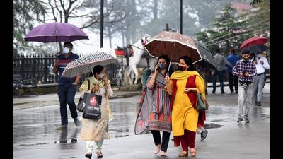 People observe Covid-appropriate norms while taking a stroll amid light showers on The Ridge in Shimla on Friday. (Deepak Sansta/HT) People observe Covid-appropriate norms while taking a stroll amid light showers on The Ridge in Shimla on Friday. (Deepak Sansta/HT)