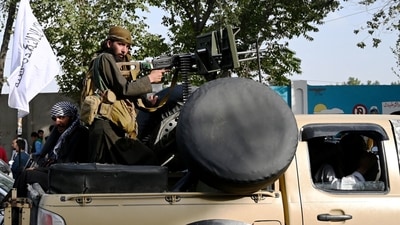 Taliban fighters travel with weapons mounted on a vehicle in Kabul on August 19, 2021. (AFP Photo)