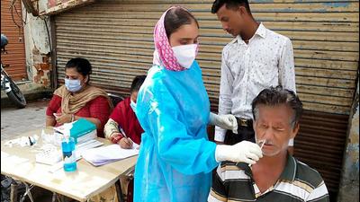 A healthcare worker collects a nasal sample of a man for Covid test in Jammu on Friday. (ANI)
