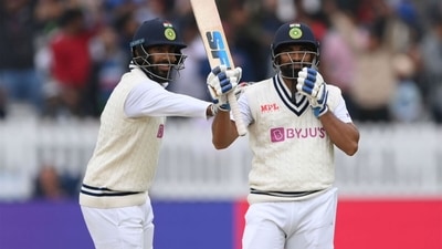 Mohammed Shami (R) raises his bat after reaching a fifty as Jasprit Bumrah pats him on the shoulder. (Getty) Mohammed Shami (R) raises his bat after reaching a fifty as Jasprit Bumrah pats him on the shoulder. (Getty)