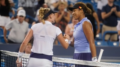 Jil Teichmann, left, of Switzerland, is congratulated by Naomi Osaka, of Japan, on Teichmann's win during the Western & Southern Open tennis tournament Thursday, Aug. 19, 2021, in Mason, Ohio. (AP Photo/Darron Cummings) (AP) Jil Teichmann, left, of Switzerland, is congratulated by Naomi Osaka, of Japan, on Teichmann's win during the Western & Southern Open tennis tournament Thursday, Aug. 19, 2021, in Mason, Ohio. (AP Photo/Darron Cummings) (AP)