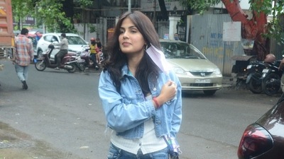 Rhea Chakraborty takes off her mask to pose for photographers. Rhea Chakraborty takes off her mask to pose for photographers.