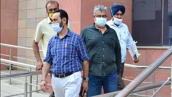 Davinder Sandhu (in green shirt), director of WWICS that developed Green Meadows in Mohali, has been sent to two-day police custody. (HT Photo)